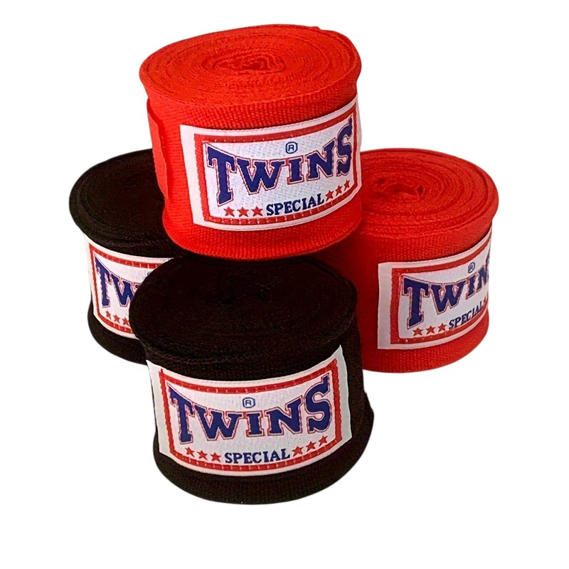 Three rolls of Twins Special boxing hand wraps, two red and one black